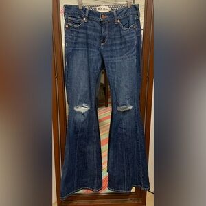 Women’s Ariat flare jeans with rips in the knees